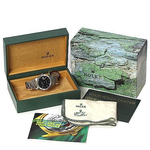The image shows a Rolex Date 15210 Men's Stainless Steel Black Dial 15210 Men's Stainless Steel Black Dial model watch placed in its open green and wooden box, alongside manuals, a cleaning cloth, and an outer box.
