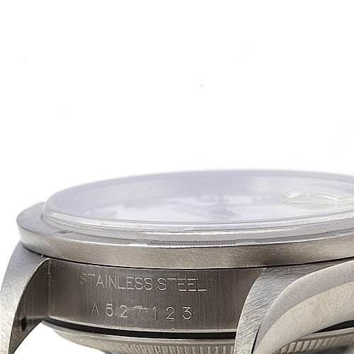 This image shows a side view of the casing of a Rolex Date 15210 Men's Stainless Steel White Dial 15210 Men's Stainless Steel White Dial model watch, highlighting the stainless steel material and part of the serial number.