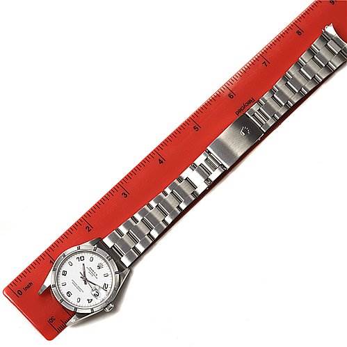 The image shows a full view of a Rolex Date 15210 Men's Stainless Steel White Dial 15210 Men's Stainless Steel White Dial watch laid flat alongside a ruler, highlighting the watch face and metal bracelet.