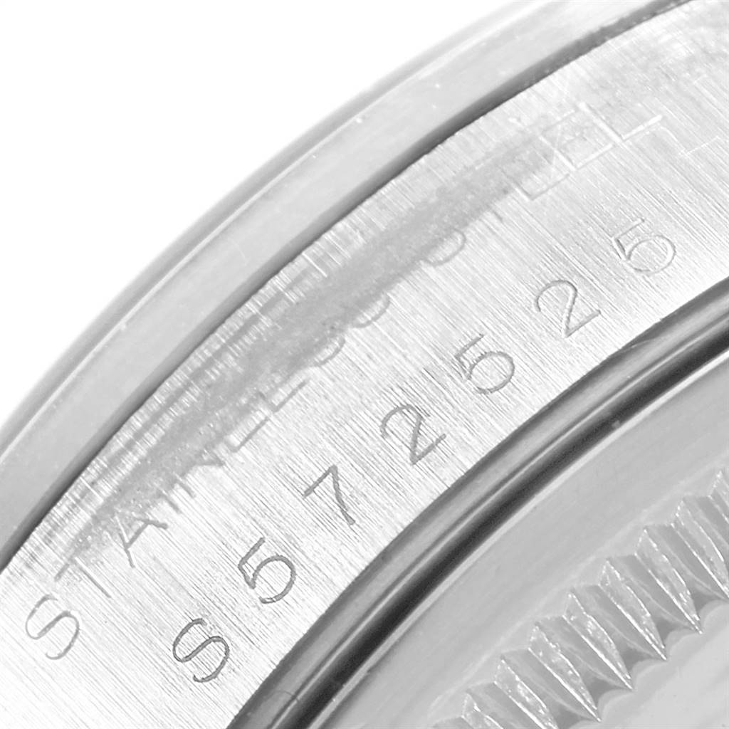 This is a close-up image showing the engraved serial number and stainless steel inscription on the case of a Rolex Date 15200 Men's Stainless Steel White Dial 15200 Men's Stainless Steel White Dial watch.