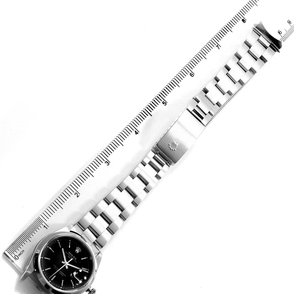 This image shows a Rolex Date 15200 Men's Stainless Steel Black Dial 15200 Men's Stainless Steel Black Dial model watch laid flat with a closed clasp and a ruler beside it for scale.