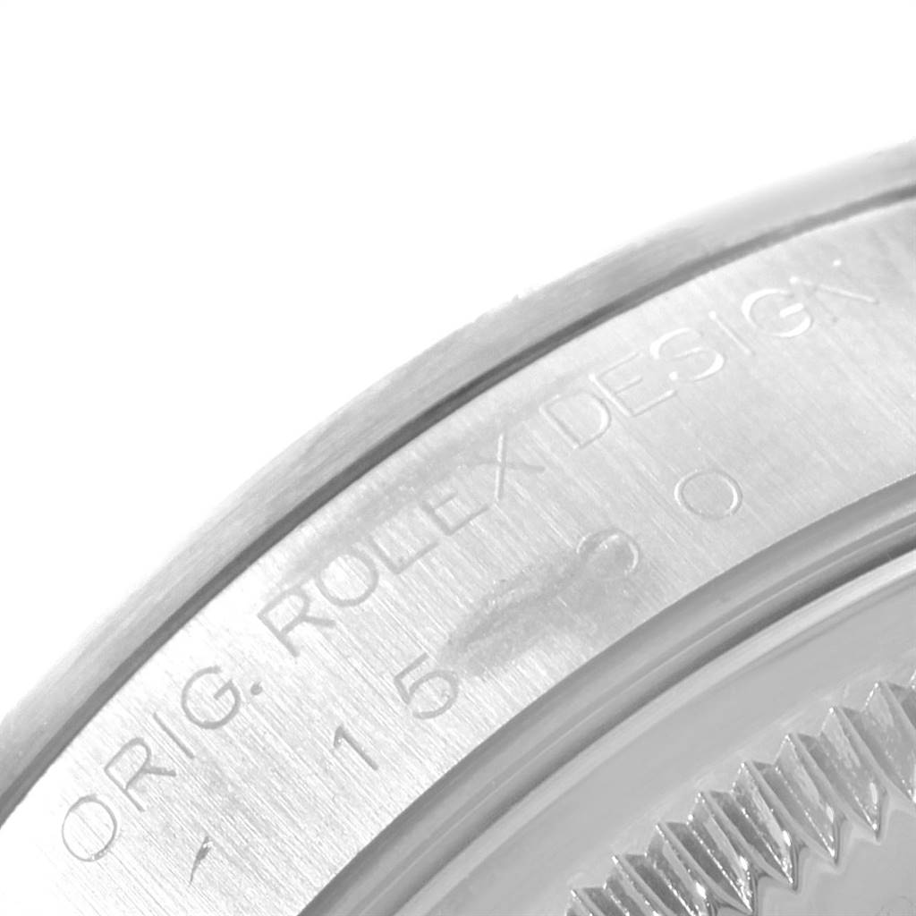 The image shows a close-up angle of the bezel and part of the case back of a Rolex Date 15200 Men's Stainless Steel Black Dial 15200 Men's Stainless Steel Black Dial model watch, with engraved text.