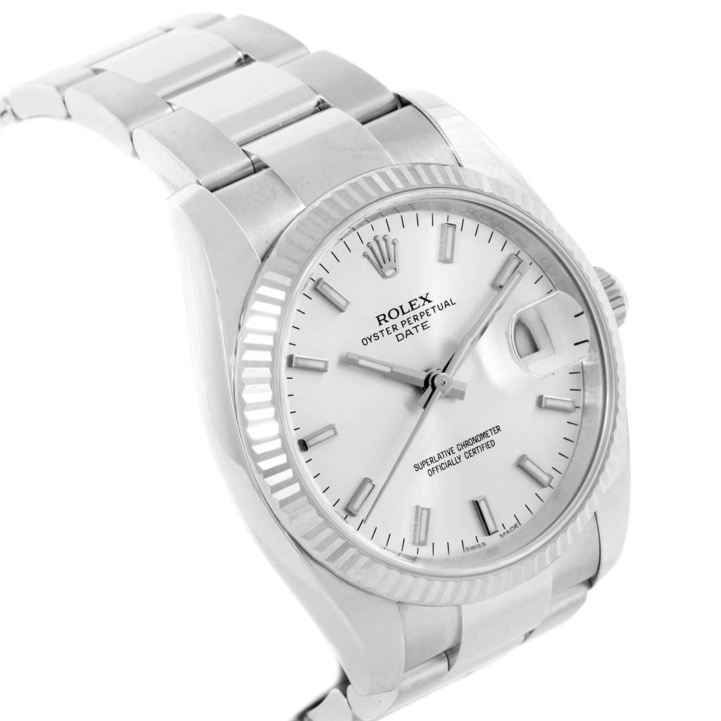 This image shows a Rolex Date 115234 Men's Stainless Steel Silver Dial 115234 Men's Stainless Steel Silver Dial model watch from an angled view, highlighting the face, bezel, and part of the bracelet.