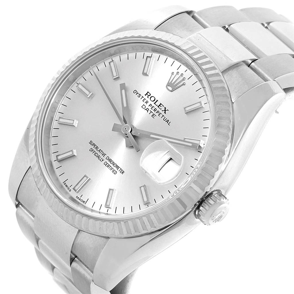 The image shows a Rolex Oyster Perpetual Date model watch at an angled close-up, displaying the face, crown, bezel, and part of the bracelet.