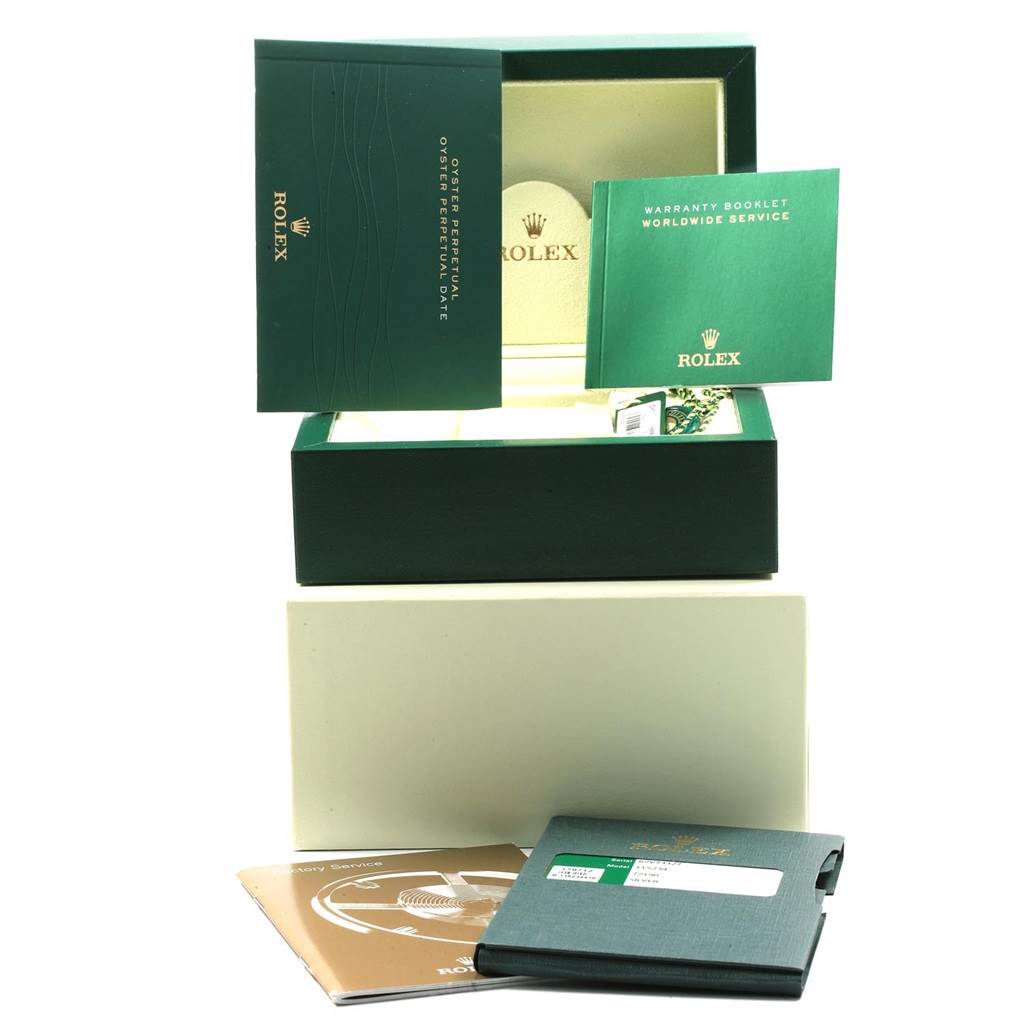 The image shows the packaging, warranty booklet, and other documents for the Rolex Date 115234 Men's Stainless Steel Silver Dial 115234 Men's Stainless Steel Silver Dial model watch.