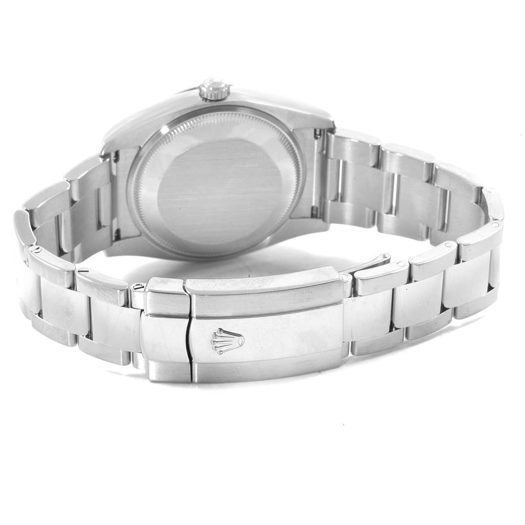 The image shows the back view of the Rolex Date 115234 Men's Stainless Steel Silver Dial 115234 Men's Stainless Steel Silver Dial model, highlighting the case back and the clasp of the metal bracelet.