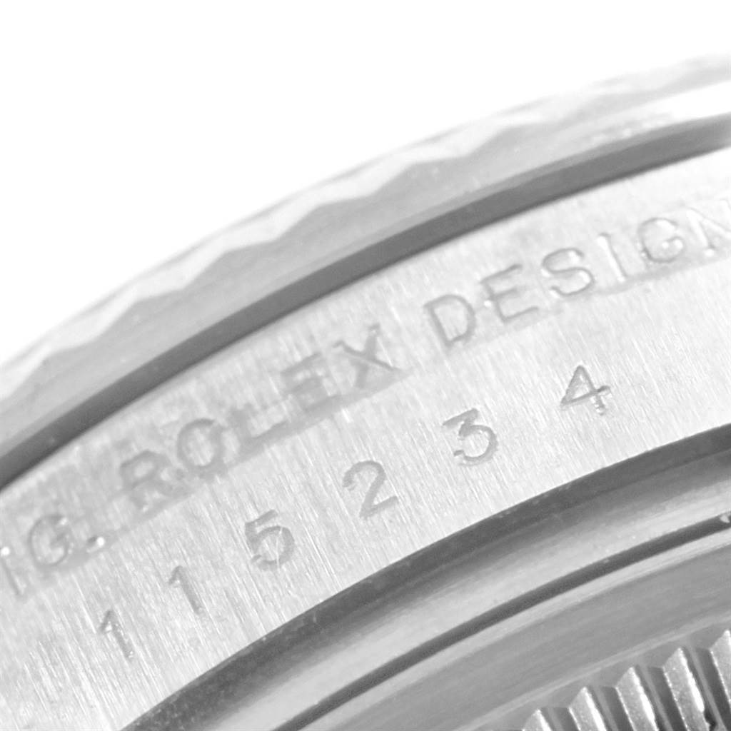 This close-up image shows the side of the case with engravings on a Rolex Date 115234 Men's Stainless Steel Silver Dial 115234 Men's Stainless Steel Silver Dial model watch.