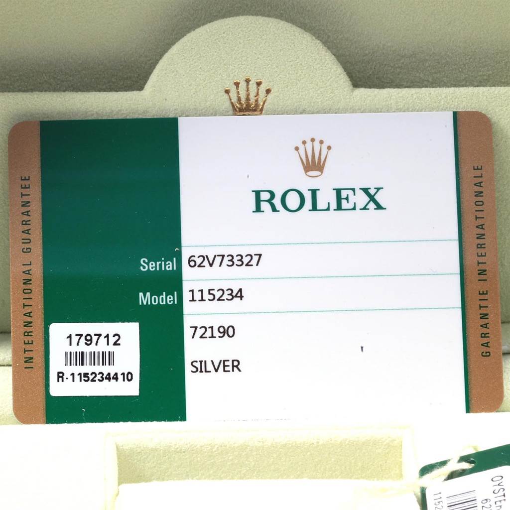 The image shows the international guarantee card for the Rolex Date 115234 Men's Stainless Steel Silver Dial 115234 Men's Stainless Steel Silver Dial model watch.