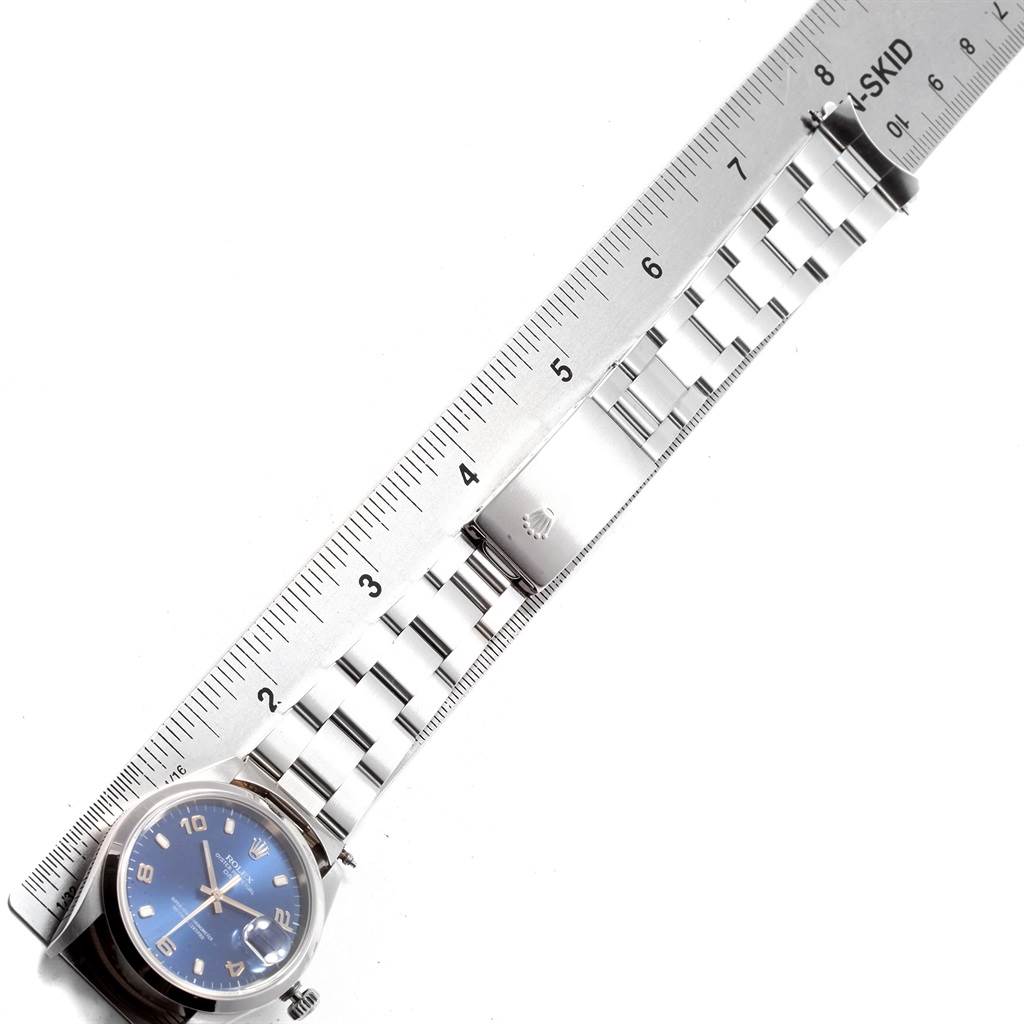 The image shows an overhead view of a Rolex Date 15200 Men's Stainless Steel Blue Dial 15200 Men's Stainless Steel Blue Dial model watch with a blue dial and stainless steel bracelet next to a ruler.