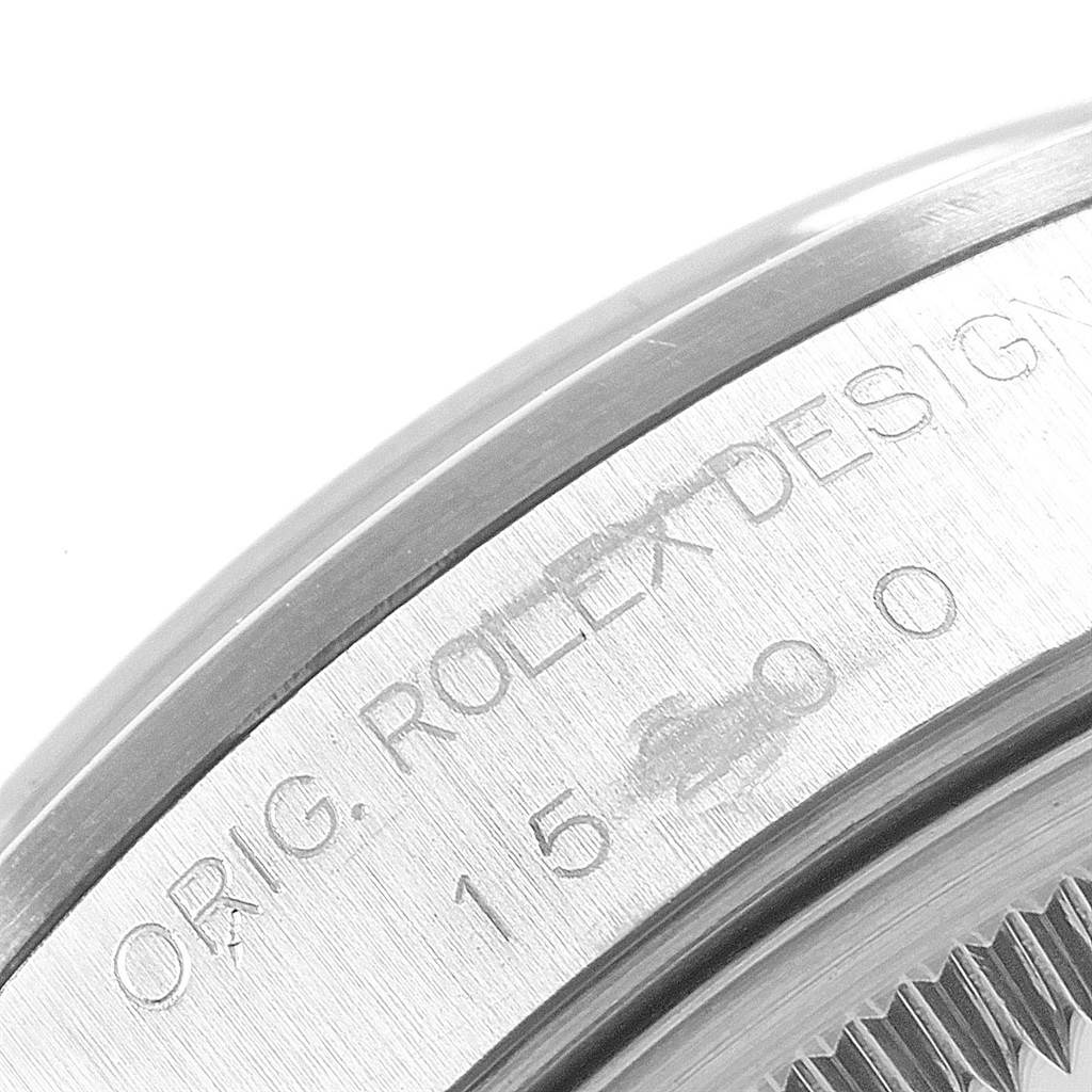 This is a close-up of the engraved side of a Rolex Date 15200 Men's Stainless Steel Blue Dial 15200 Men's Stainless Steel Blue Dial model watch, showing the serial number and "ROLEX DESIGN" text.