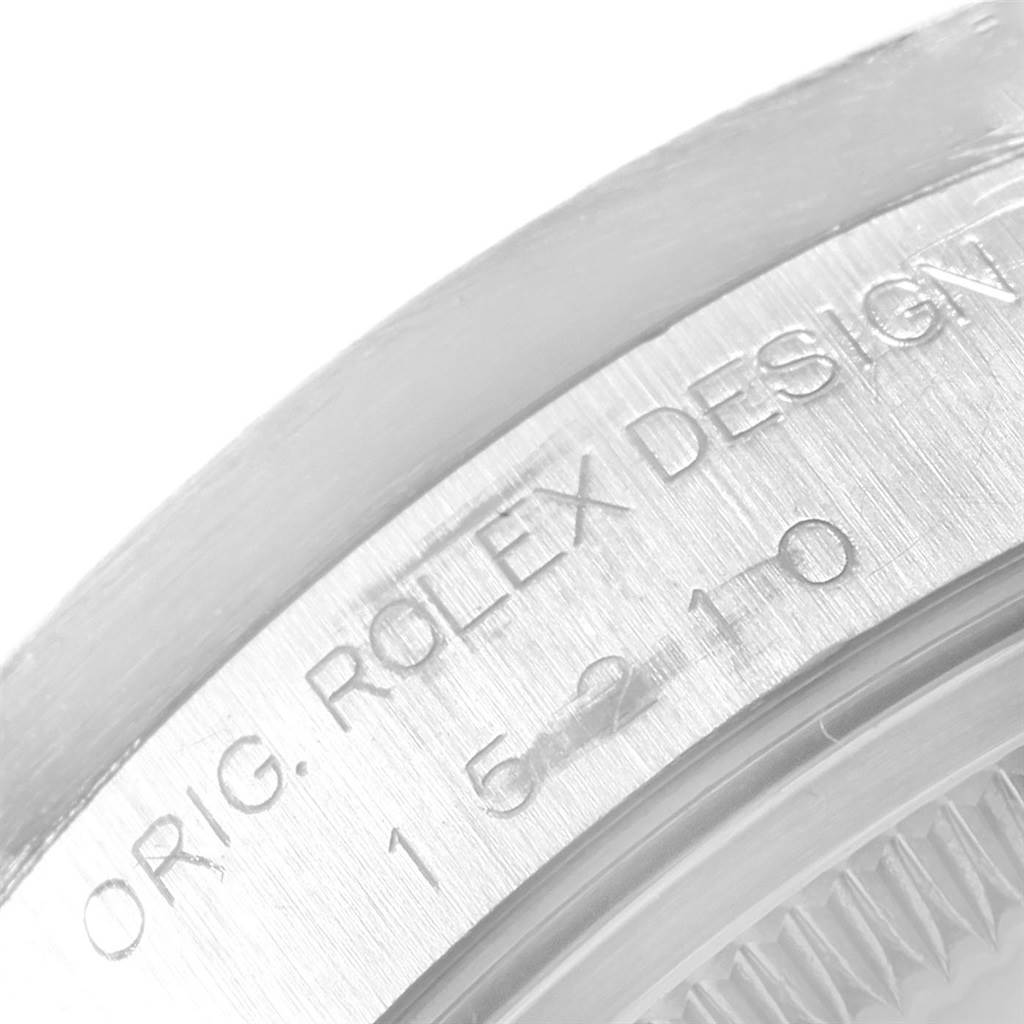 The image shows a close-up of the case engraving on a Rolex Date 15210 Men's Stainless Steel Blue Dial 15210 Men's Stainless Steel Blue Dial model watch.