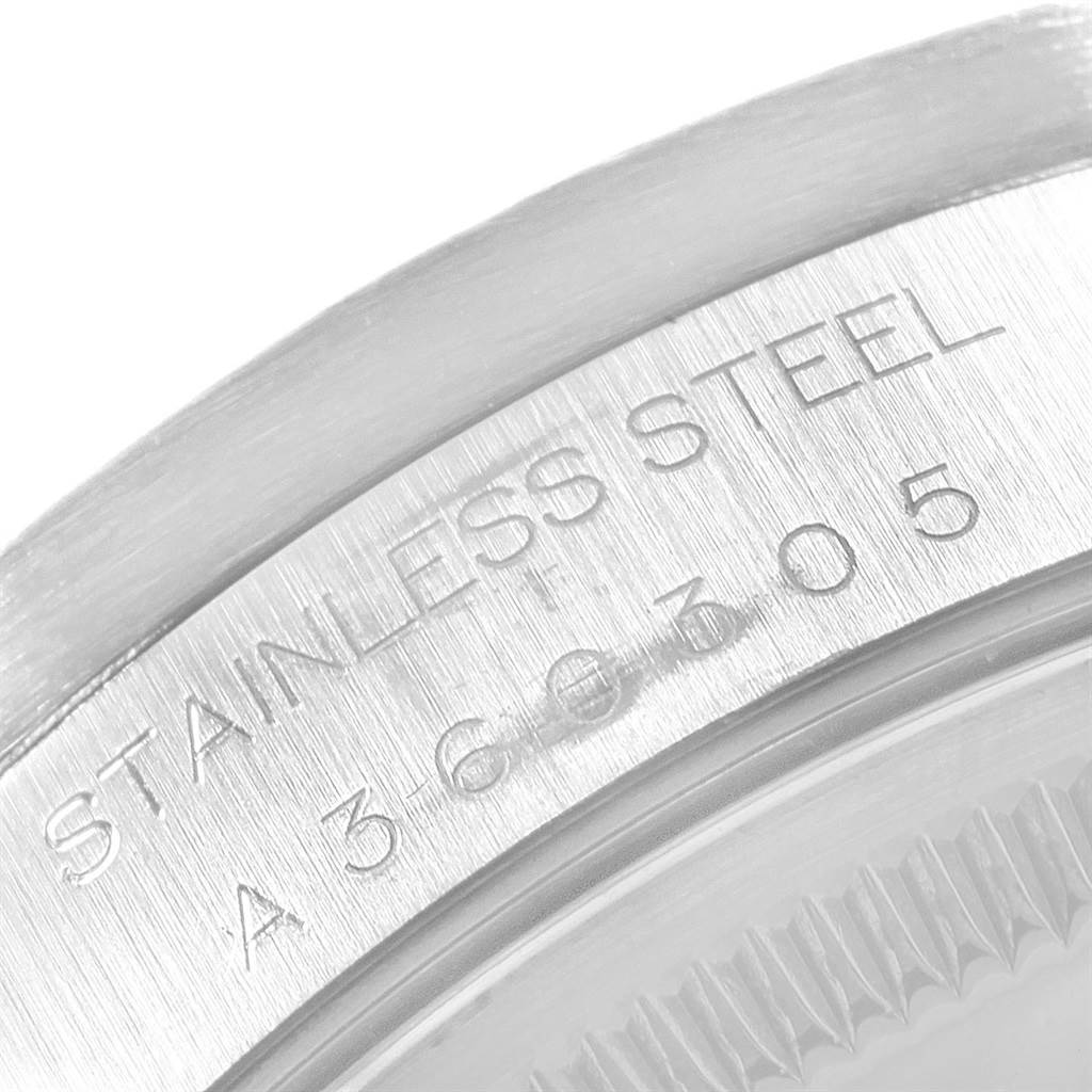 The image shows a close-up angle of the edge of the caseback and the serial engraving on a Rolex Date 15210 Men's Stainless Steel Blue Dial 15210 Men's Stainless Steel Blue Dial model.