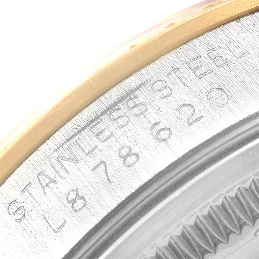 The image shows a close-up of the serial number engraving on the stainless steel case of a Rolex Date 15223 Men's Steel and Gold (two tone) Champagne Dial 15223 Men's Steel and Gold (two tone) Champagne Dial model.