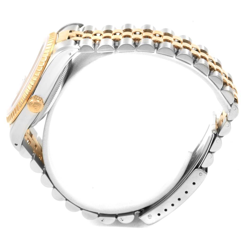 The image shows a side view of a Rolex Date 15223 Men's Steel and Gold (two tone) Black Dial 15223 Men's Steel and Gold (two tone) Black Dial model watch focusing on the crown, case, and bracelet.