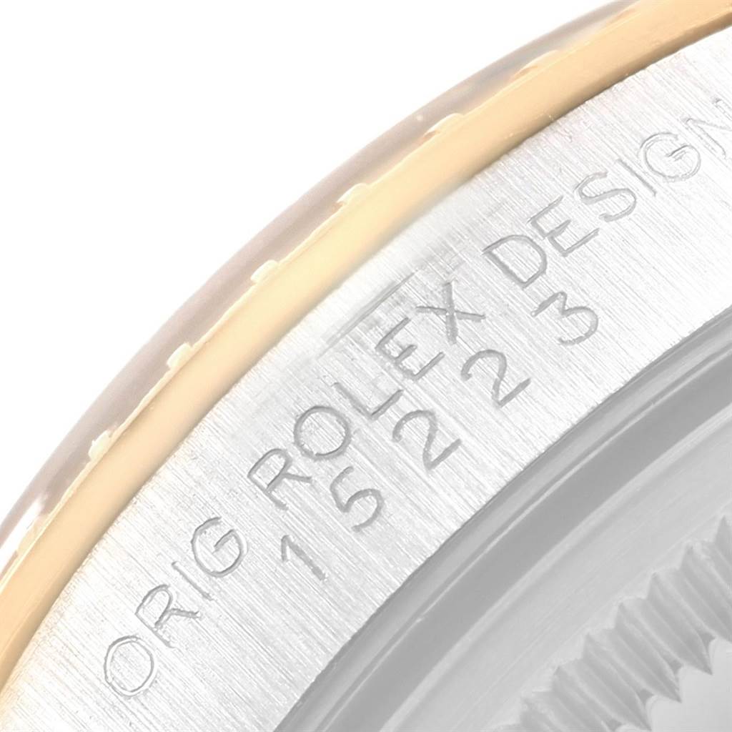 This close-up image shows the side engraving and part of the bezel of the Rolex Date 15223 Men's Steel and Gold (two tone) Black Dial 15223 Men's Steel and Gold (two tone) Black Dial model watch.