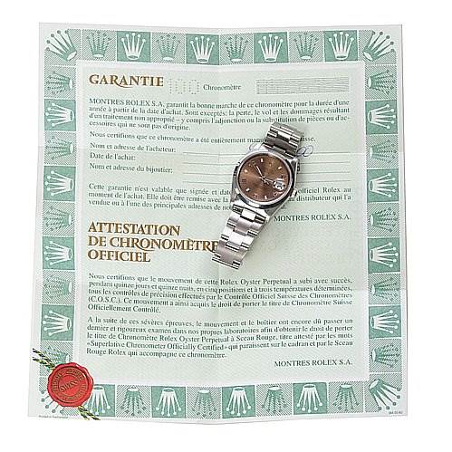 The image shows a Rolex Date 15200 Men's Stainless Steel Brown Dial 15200 Men's Stainless Steel Brown Dial model watch placed diagonally on top of its warranty certificate.