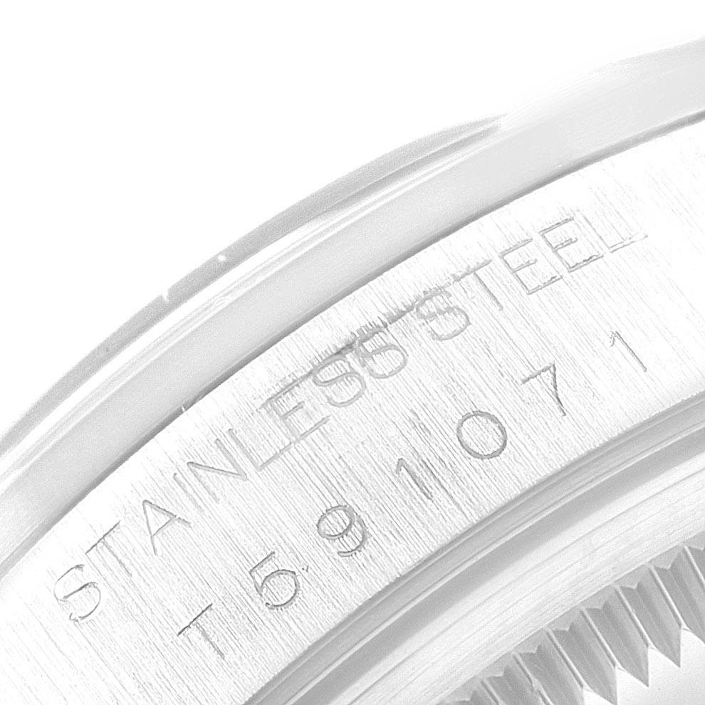 This image shows a close-up view of the serial number and "STAINLESS STEEL" engraving on the case back of a Rolex Date 15200 Men's Stainless Steel White Dial 15200 Men's Stainless Steel White Dial watch.