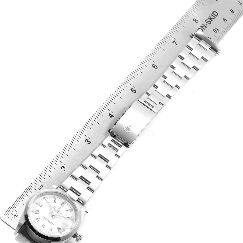 The image shows a Rolex Date 15200 Men's Stainless Steel White Dial 15200 Men's Stainless Steel White Dial model watch from an overhead angle, focusing on the face and the bracelet next to a ruler.