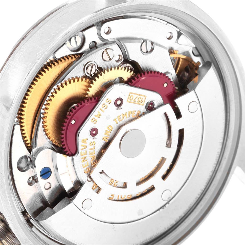 This image shows the inner mechanics of a Rolex Date 1500 Men's Stainless Steel White Dial 1500 Men's Stainless Steel White Dial model watch from the back, revealing gears and components.