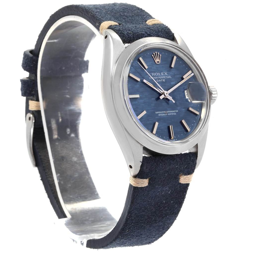 The image shows a Rolex Date 1500 Men's Stainless Steel Blue Dial 1500 Men's Stainless Steel Blue Dial model watch at a slight angle, highlighting its blue dial, case, crown, and suede strap.
