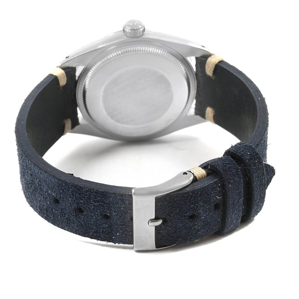 A Rolex Date 1500 Men's Stainless Steel Blue Dial 1500 Men's Stainless Steel Blue Dial model watch is shown from the back, highlighting its case back and dark strap with a metal buckle.