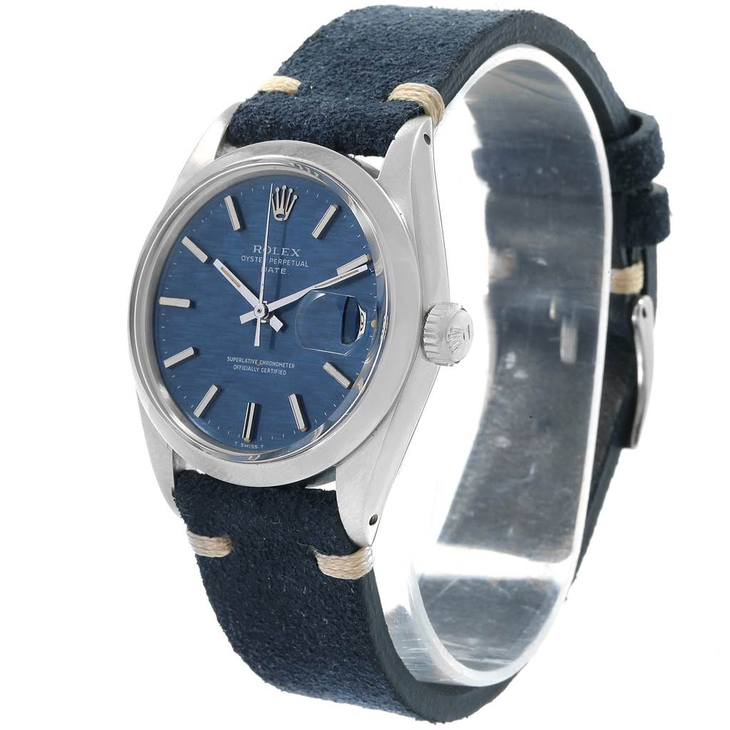 The image shows a Rolex Date 1500 Men's Stainless Steel Blue Dial 1500 Men's Stainless Steel Blue Dial model watch from an angled side view, displaying its face, bezel, crown, and leather strap.