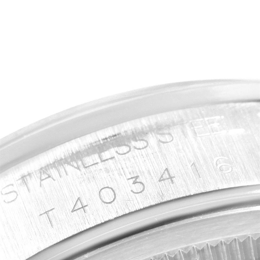 This close-up image shows the engraved serial number and part of the case back of a Rolex Date 15200 Men's Stainless Steel White Dial 15200 Men's Stainless Steel White Dial model watch.