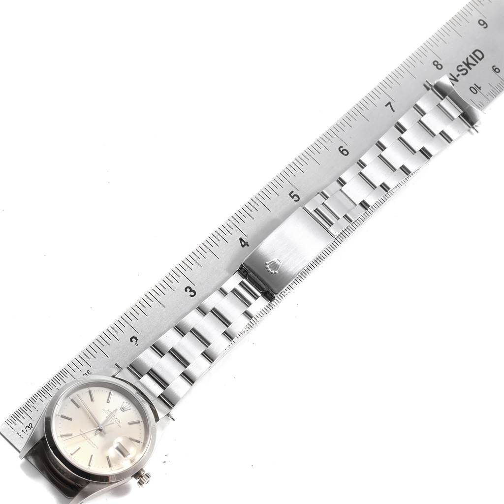 The image shows a Rolex Date 15200 Men's Stainless Steel Silver Dial 15200 Men's Stainless Steel Silver Dial model watch with a metal bracelet and clasp, measured against a ruler.