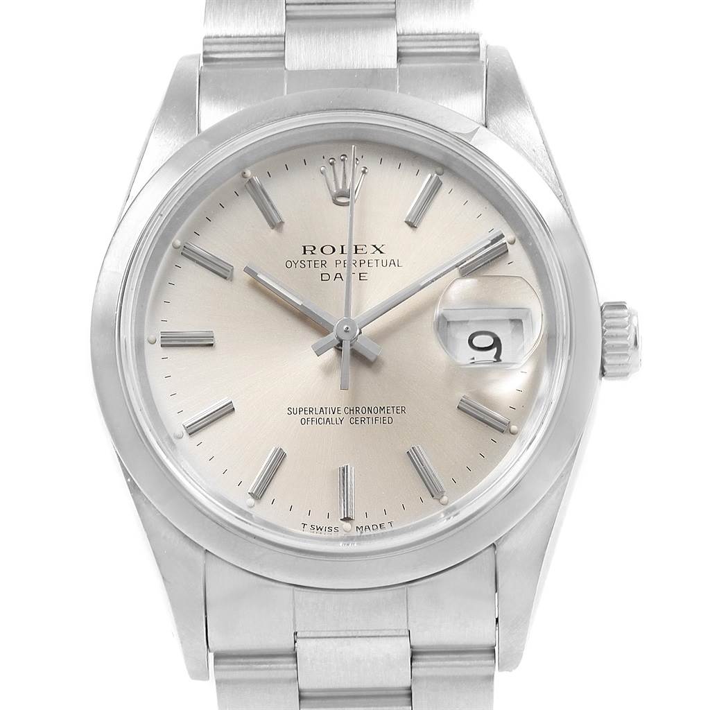 This is a top-down view of a Rolex Oyster Perpetual Date watch, showing the dial, hands, crown, and part of the bracelet.