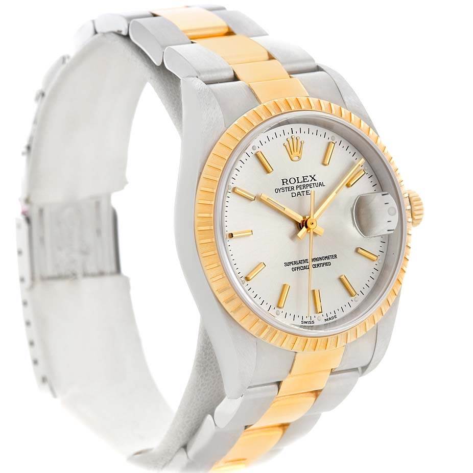 The image shows a Rolex Date 15223 Men's Steel and Gold (two tone) Silver Dial 15223 Men's Steel and Gold (two tone) Silver Dial model watch at an angle, highlighting the dial, two-tone bracelet, bezel, and crown.