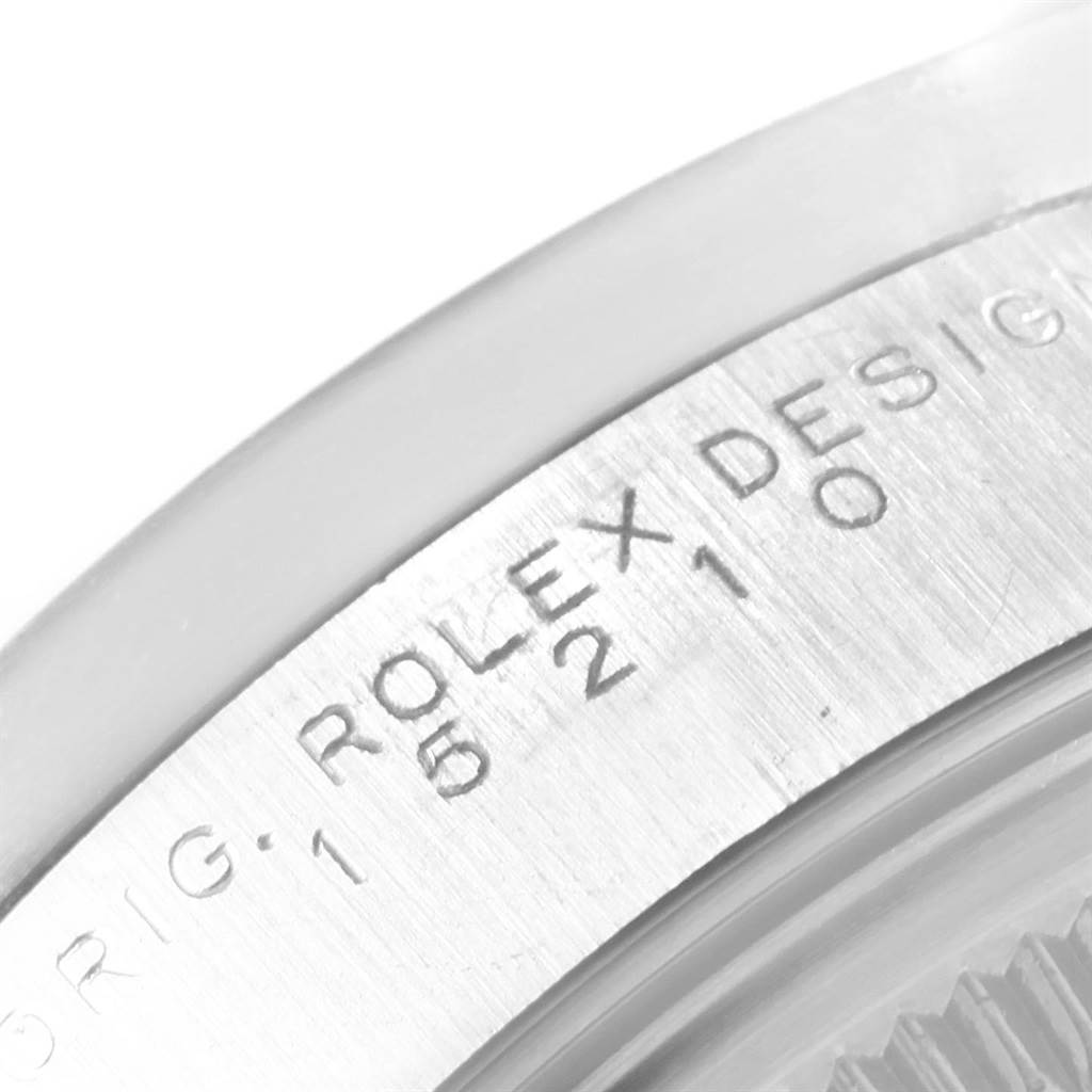 This image shows a close-up of the Rolex Date 15210 Men's Stainless Steel White Dial 15210 Men's Stainless Steel White Dial model's serial number engraving on the watch case.