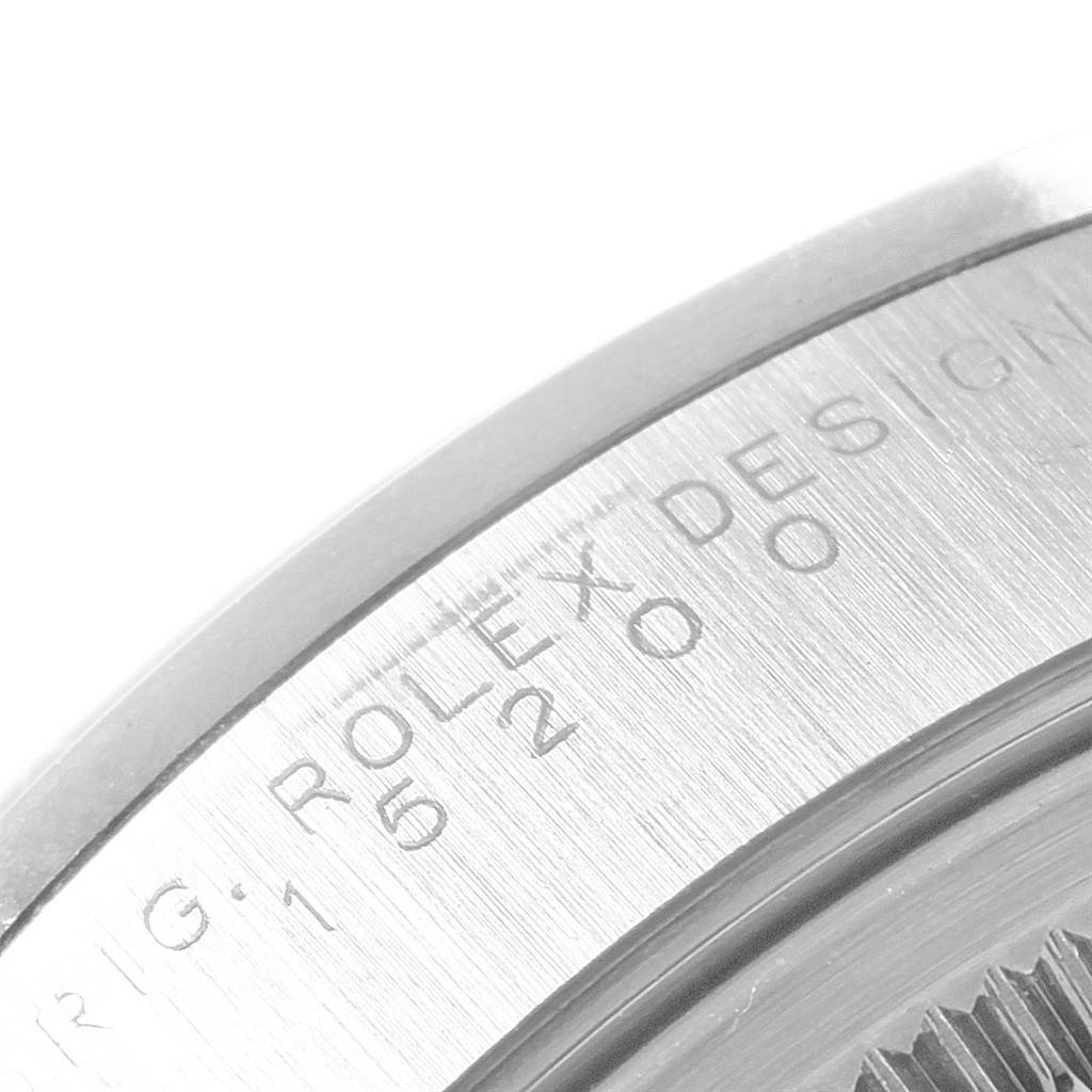The image shows a close-up view of the side of a Rolex Date 15200 Men's Stainless Steel Black Dial 15200 Men's Stainless Steel Black Dial model watch, focusing on the engraved text.
