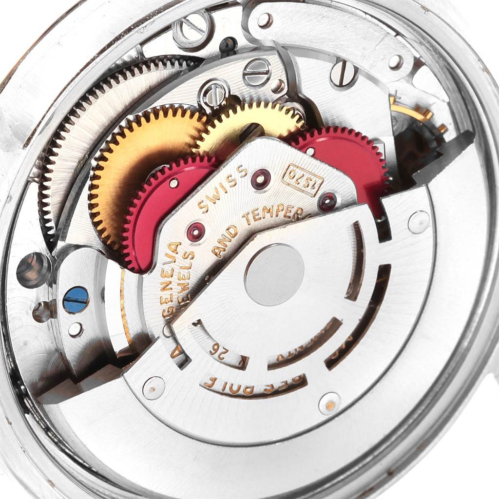 The image shows an inside view of the Rolex Date 1500 Men's Stainless Steel Silver Dial 1500 Men's Stainless Steel Silver Dial model's mechanism, highlighting gears and components.