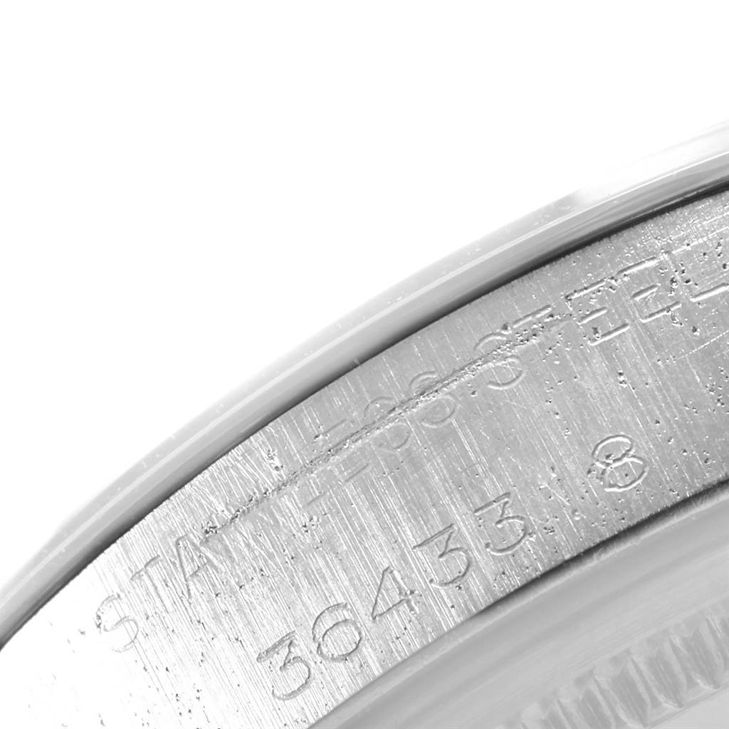 This image shows a close-up of the inner rim and engraved serial numbers of a Rolex Date 1500 Men's Stainless Steel Silver Dial 1500 Men's Stainless Steel Silver Dial model watch.