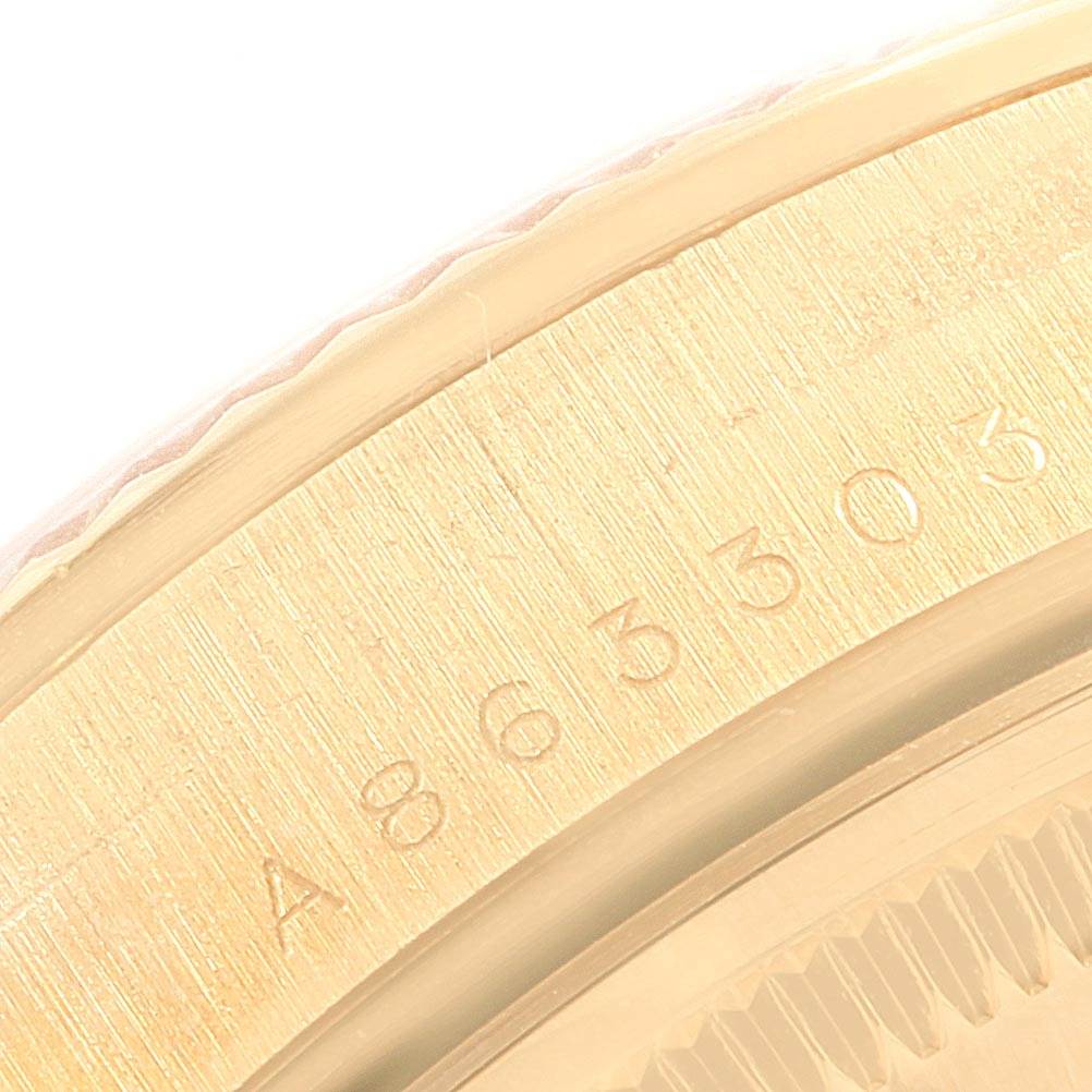 The image shows a close-up of the serial number engraving on the gold casing of a Rolex Date 15238 Men's Yellow Gold Champagne Dial 15238 Men's Yellow Gold Champagne Dial model watch.