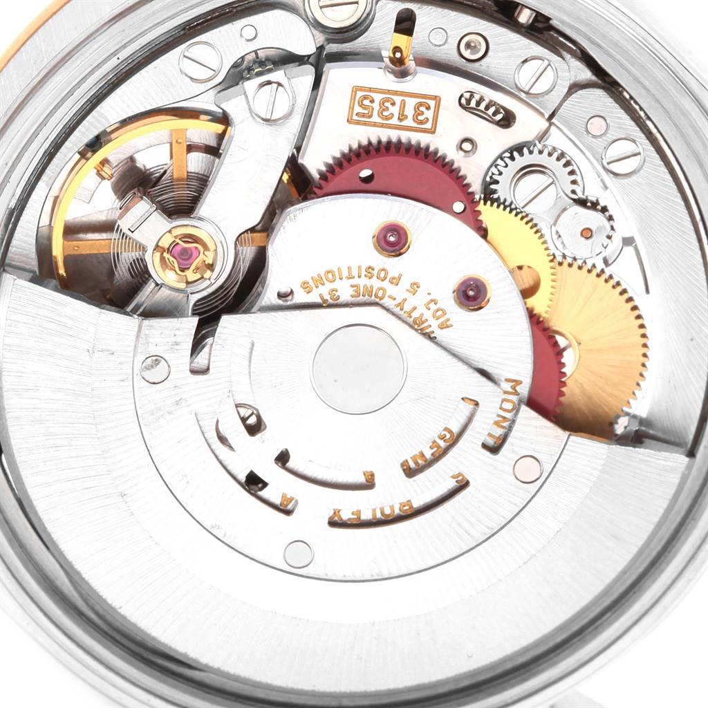 This image shows the intricate movement and gears of a Rolex Date 15203 Men's Steel and Gold (two tone) Blue Dial 15203 Men's Steel and Gold (two tone) Blue Dial model watch from an overhead view.