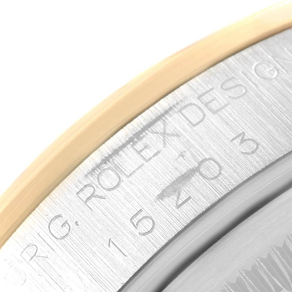 This image shows a close-up of the engraved serial and model numbers on the case of a Rolex Date 15203 Men's Steel and Gold (two tone) Blue Dial 15203 Men's Steel and Gold (two tone) Blue Dial watch.