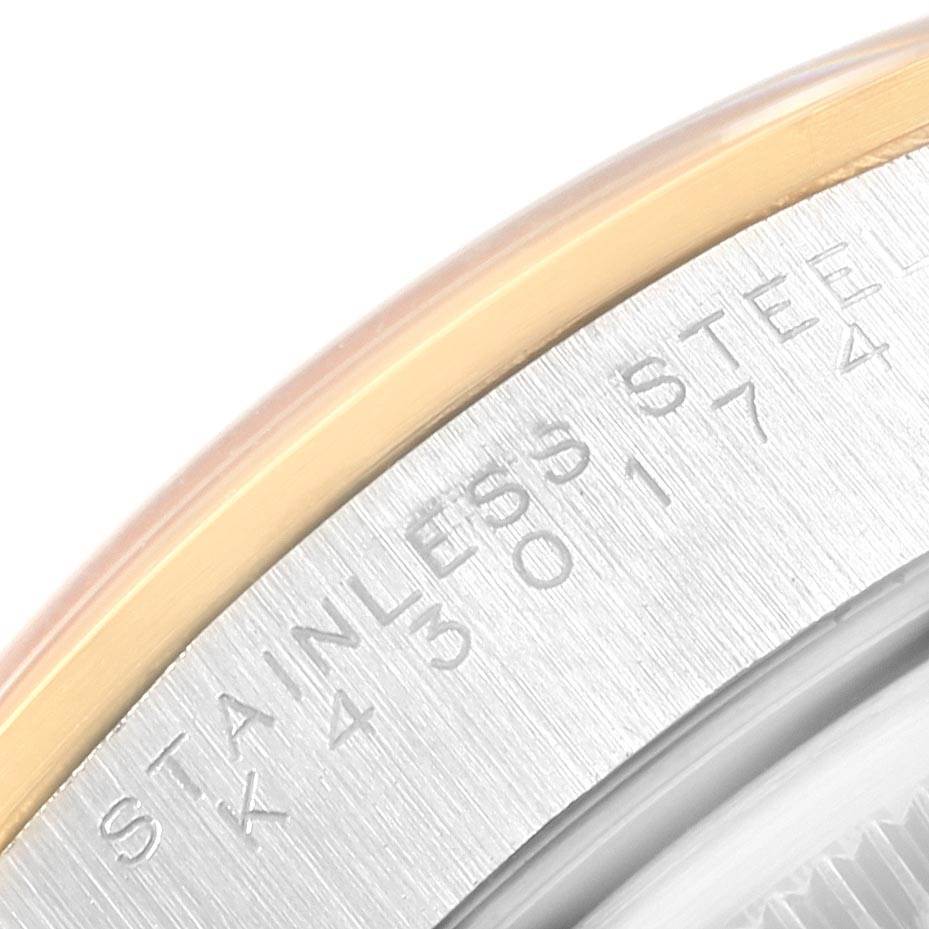 This close-up shows part of the bezel and engraved case of the Rolex Date 15203 Men's Steel and Gold (two tone) Champagne Dial 15203 Men's Steel and Gold (two tone) Champagne Dial model watch, highlighting the "Stainless Steel" inscription.