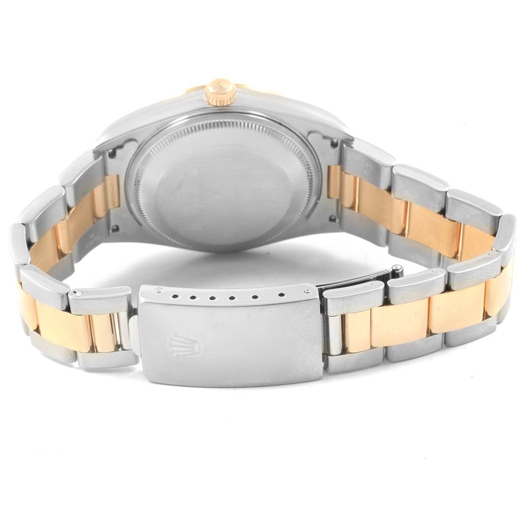 The image shows the case back and clasp of a Rolex Date 15203 Men's Steel and Gold (two tone) Champagne Dial 15203 Men's Steel and Gold (two tone) Champagne Dial watch, with a two-tone metal bracelet.