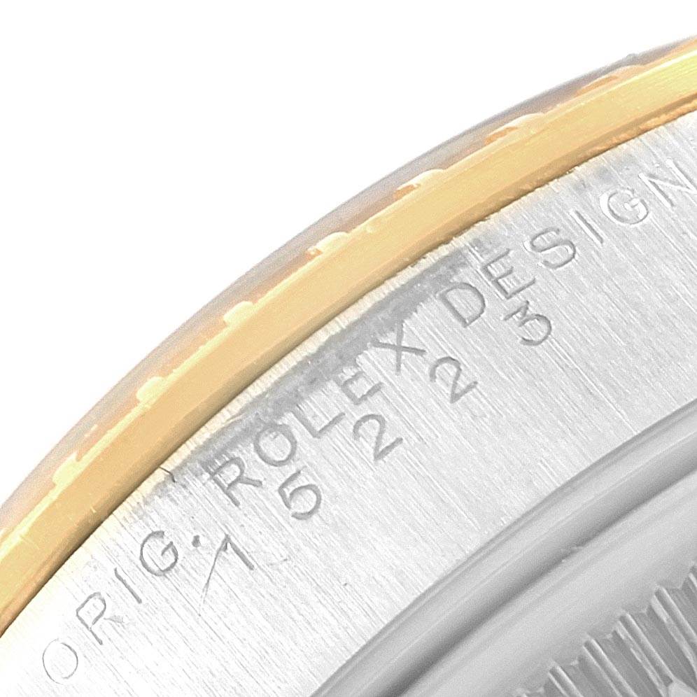 This image shows a close-up of the casing with engraving on a Rolex Date 15223 Men's Steel and Gold (two tone) Champagne Dial 15223 Men's Steel and Gold (two tone) Champagne Dial watch, featuring parts of the bezel and caseback.