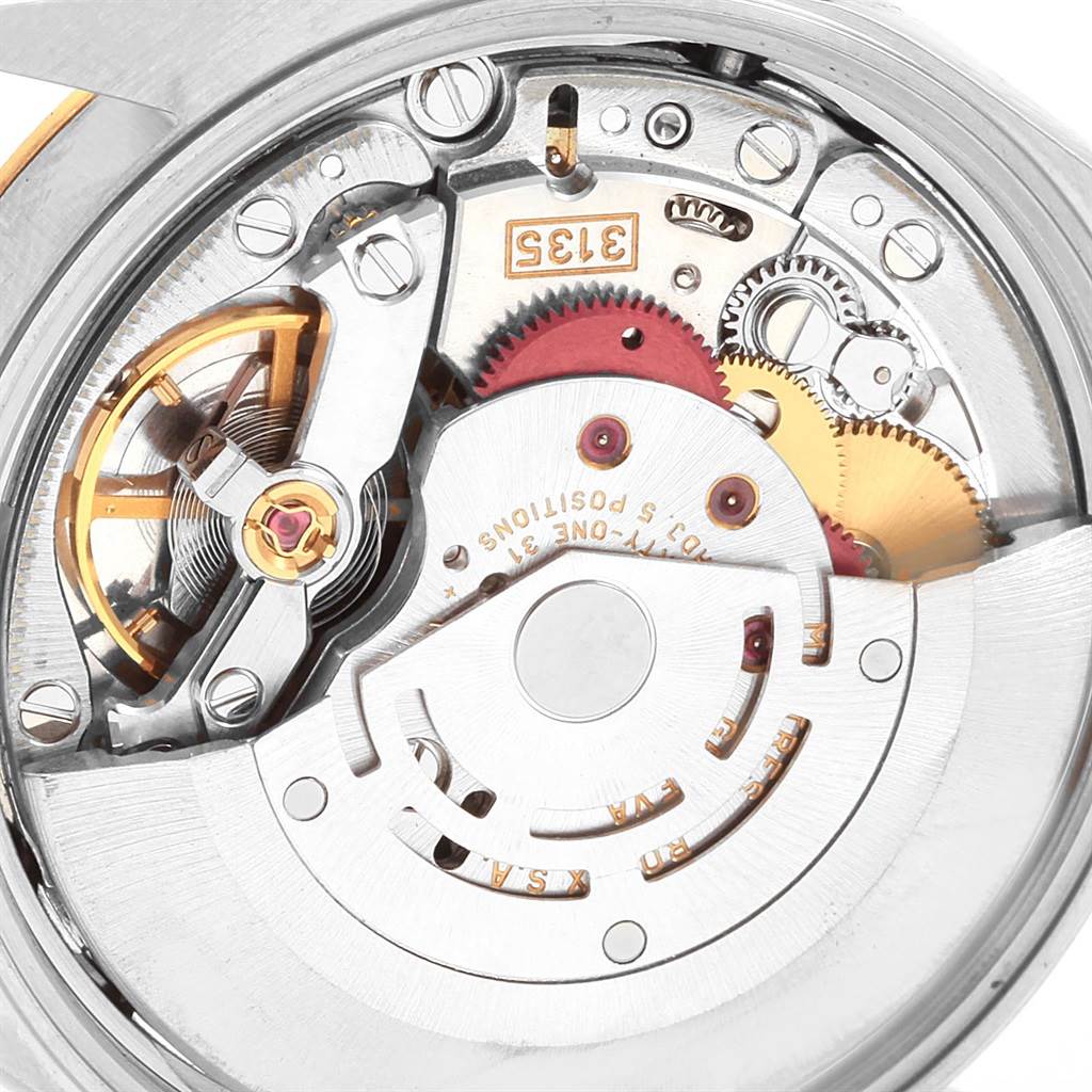 The image shows a close-up of the movement mechanism of a Rolex Date 15223 Men's Steel and Gold (two tone) Champagne Dial 15223 Men's Steel and Gold (two tone) Champagne Dial model watch, highlighting gears and intricate internal components.