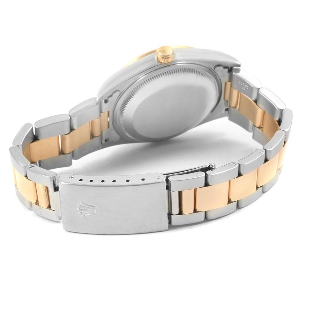 The image shows the back case and bracelet of a Rolex Date 15223 Men's Steel and Gold (two tone) Champagne Dial 15223 Men's Steel and Gold (two tone) Champagne Dial model watch from a low-angle view.