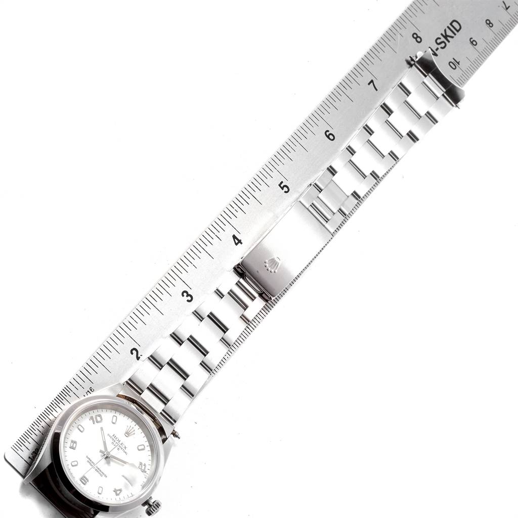 The image shows a Rolex Date 15200 Men's Stainless Steel White Dial 15200 Men's Stainless Steel White Dial model watch from a top-down angle, displaying the watch face, bracelet, and clasp alongside a ruler.