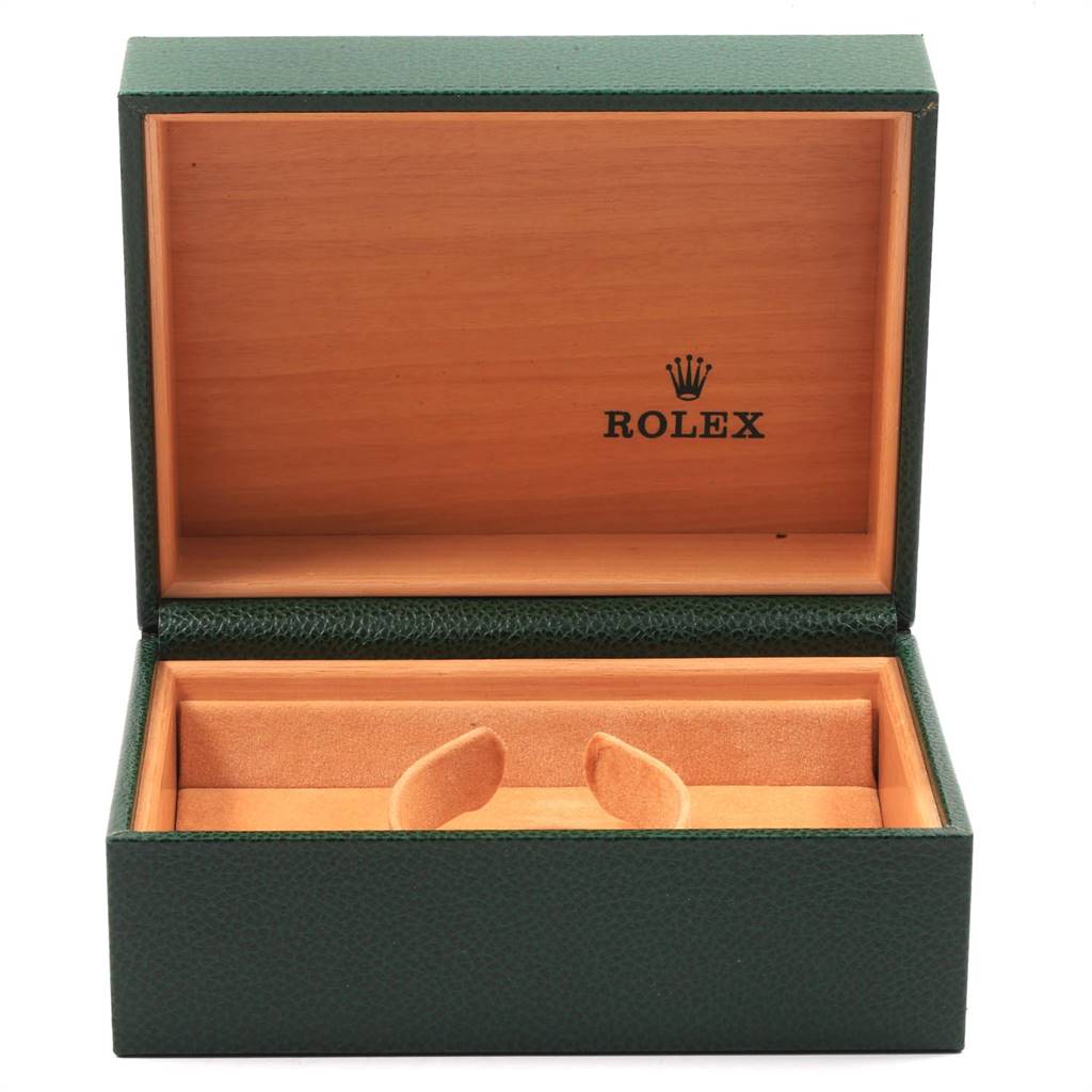 The image shows an open green and wood Rolex watch box for the Date model, with the interior empty.