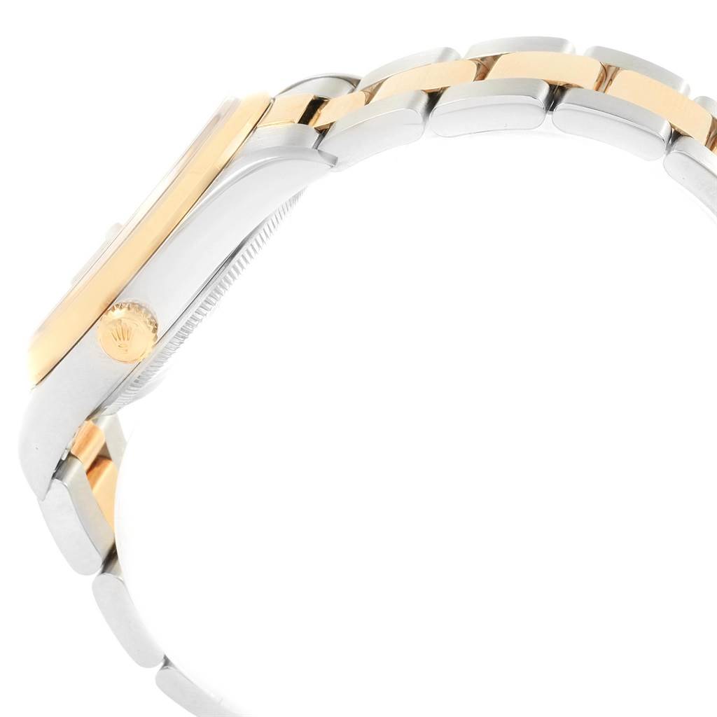 This image shows the side angle of a Rolex Date 15203 Men's Steel and Gold (two tone) Champagne Dial 15203 Men's Steel and Gold (two tone) Champagne Dial model watch, highlighting the crown and part of the two-tone bracelet.