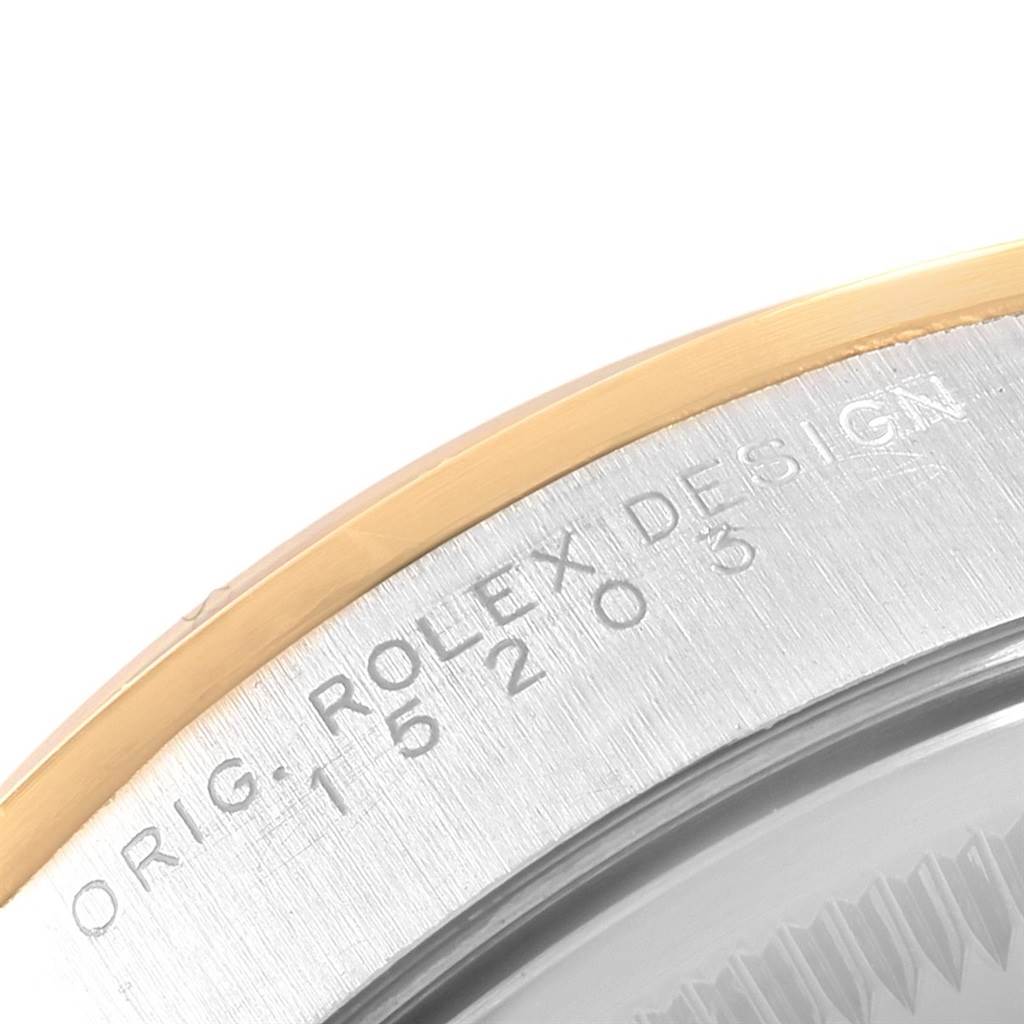 The image shows a close-up of the engraved bezel and case side of a Rolex Date 15203 Men's Steel and Gold (two tone) Champagne Dial 15203 Men's Steel and Gold (two tone) Champagne Dial model watch.