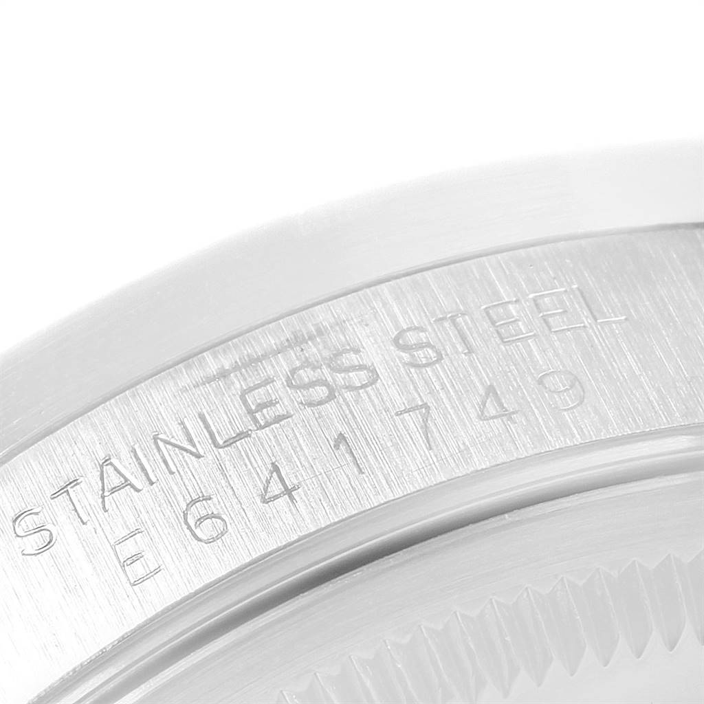 This image shows a close-up of the stainless steel caseback and inscription on a Rolex Date 15210 Men's Stainless Steel White Dial 15210 Men's Stainless Steel White Dial model watch.