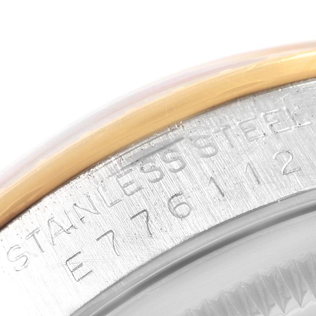 The image shows a close-up view of the stainless steel case and serial number of a Rolex Date 15223 Men's Steel and Gold (two tone) White Dial 15223 Men's Steel and Gold (two tone) White Dial model watch.
