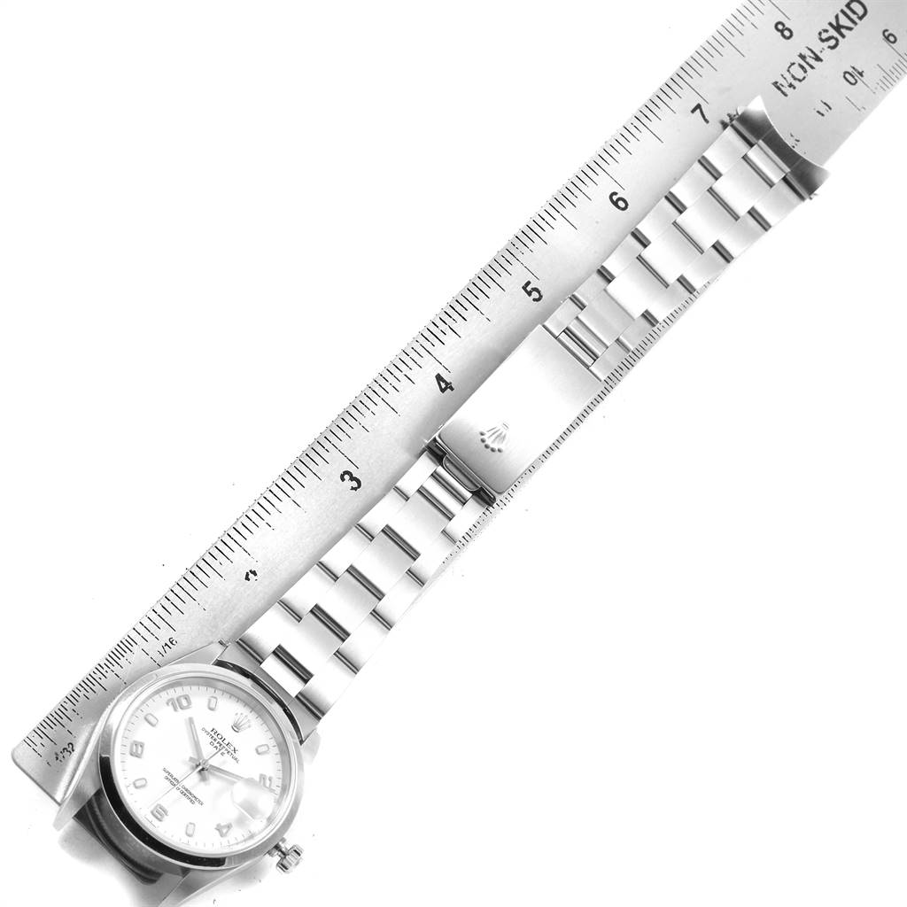 The Rolex Date 15200 Men's Stainless Steel White Dial 15200 Men's Stainless Steel White Dial model watch is shown laid flat with its bracelet extended alongside a ruler.