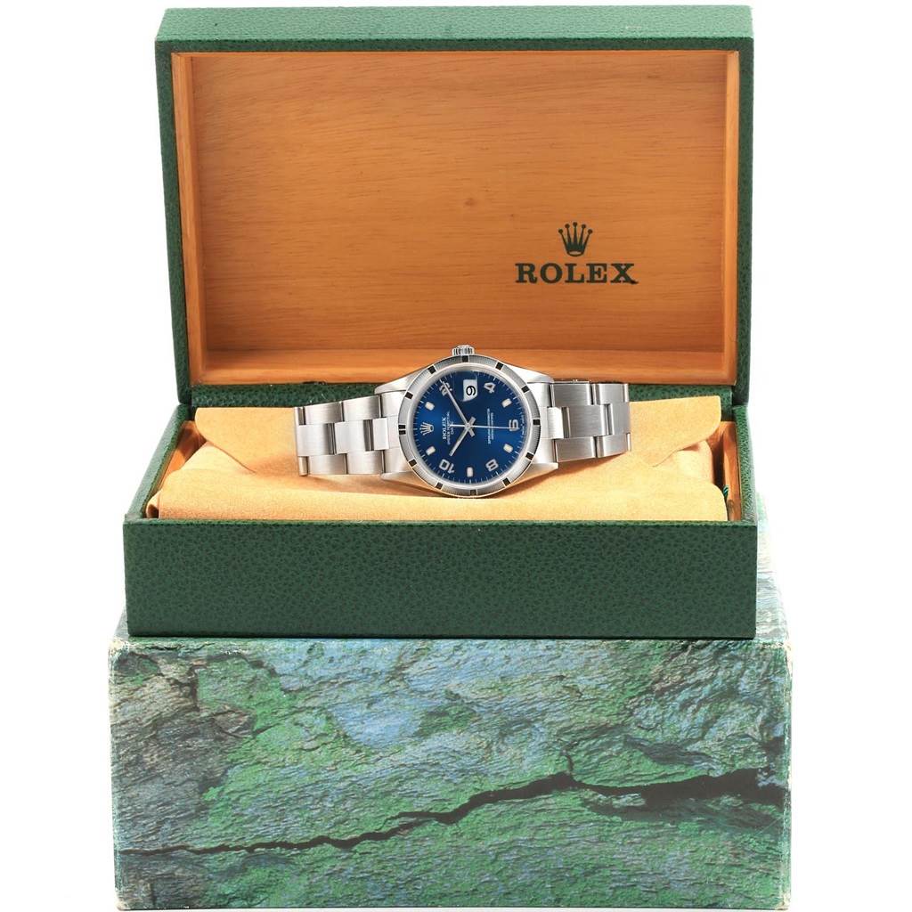 The Rolex Date 15210 Men's Stainless Steel Blue Dial 15210 Men's Stainless Steel Blue Dial model watch is shown angled from the front in an open box with its metal bracelet visible.